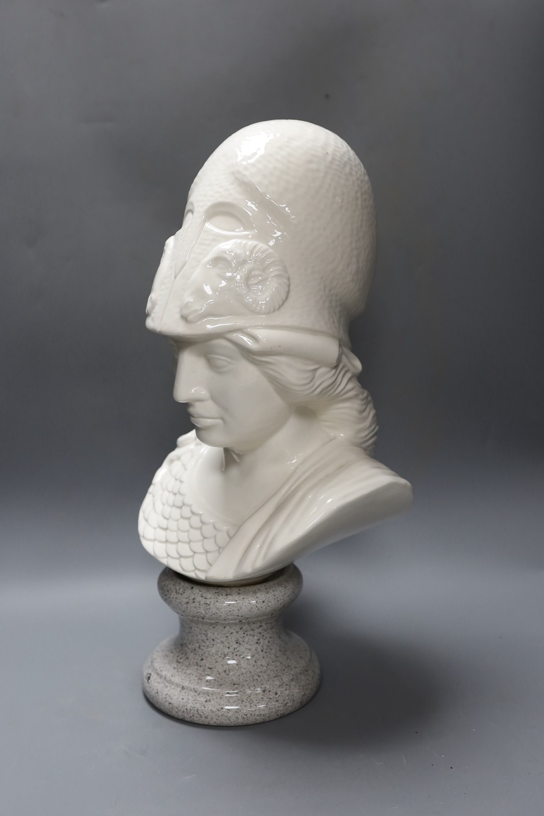 A white glazed ceramic portrait bust of Athena on faux marble plinth 49cm